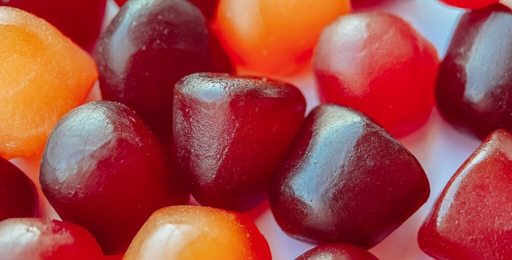 cannabis edibles, macro shot of red and yellow gummies